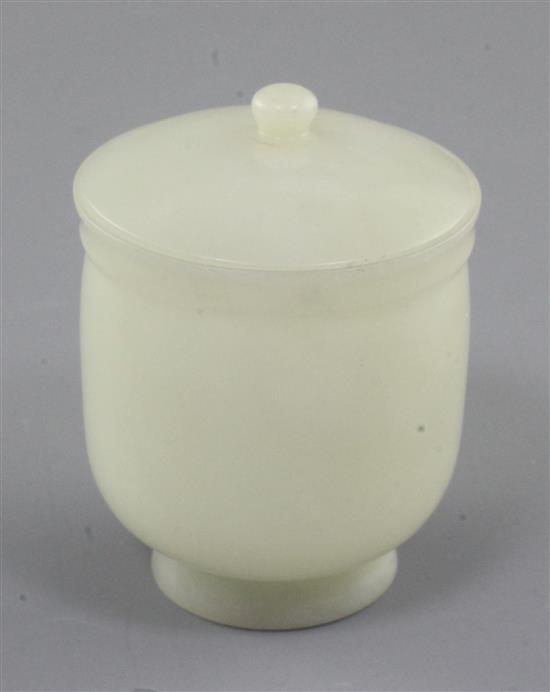 A Chinese pale celadon jade jar and cover, 19th / early 20th century, height 7.8cm, two colour wood stand